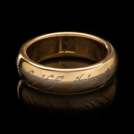 Wētā Workshop One Ring in gold plated tungsten carbide, with the Elvish inscription, on a black background